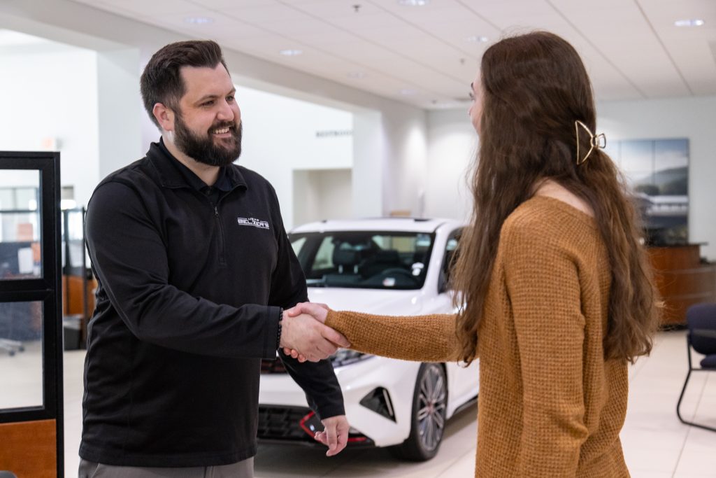 Sales Consultant with Client Shaking Hand